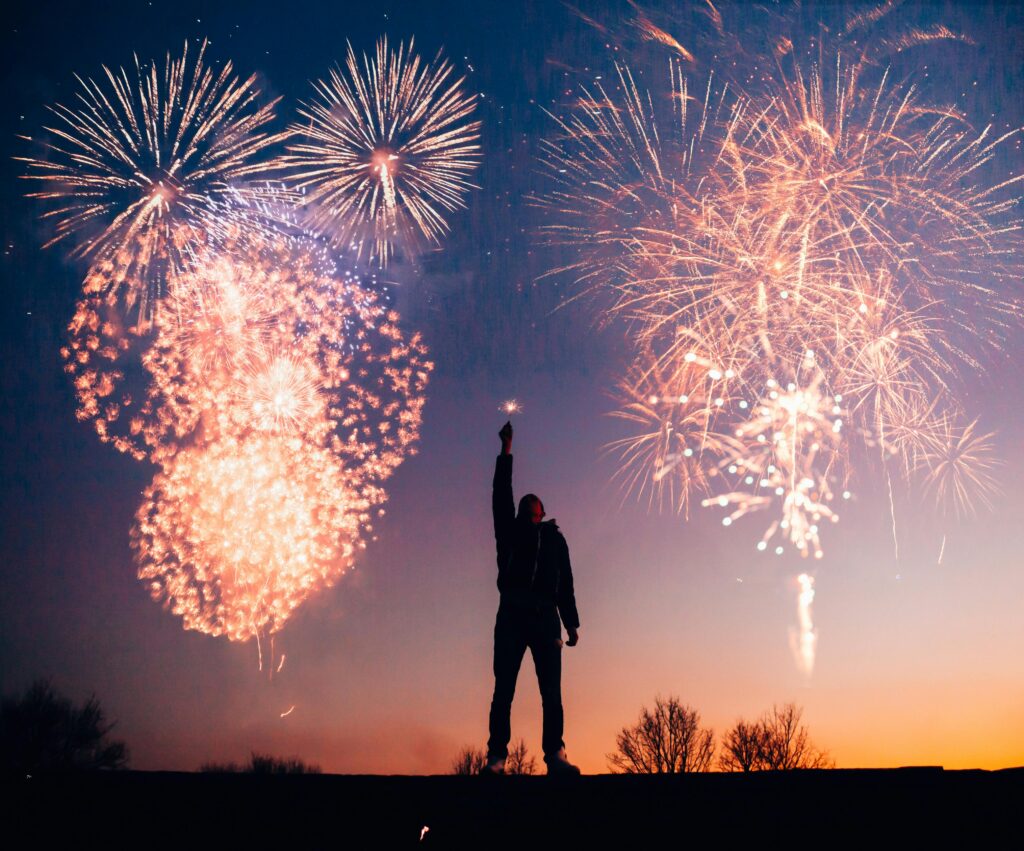 Man standing against a fireworks backdrop for July 4th