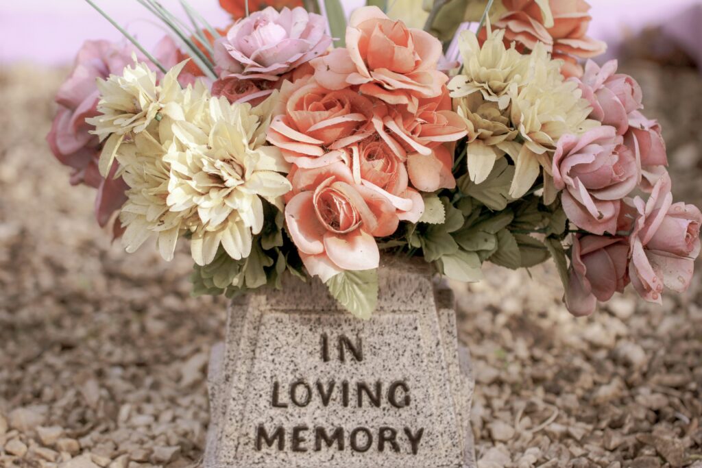 Headstone marker with flowers for grief etiquette